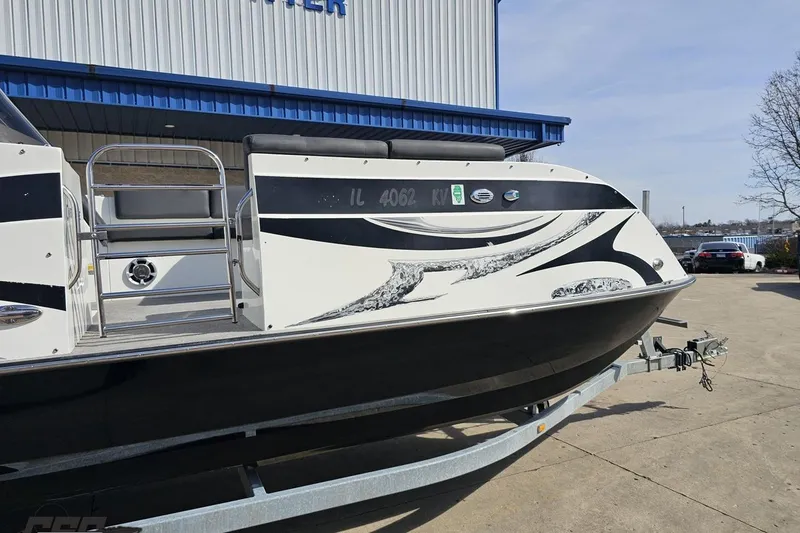 Slide: The Image of 2014 Caravelle 247 UU Razor E-Toon boat on trailer outside a building. - 5