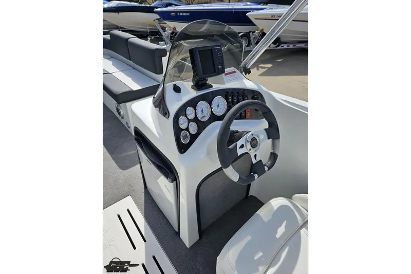 Slide: The Image of 2014 Caravelle 247 UU Razor E-Toon boat dashboard with steering wheel and gauges. - 50