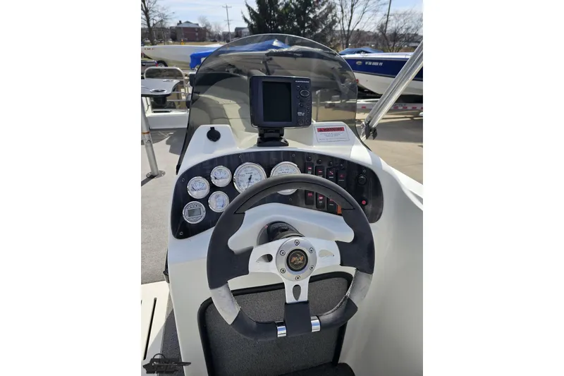 Slide: The Image of Steering console of 2014 Caravelle 247 UU Razor E-Toon boat with gauges and controls. - 51