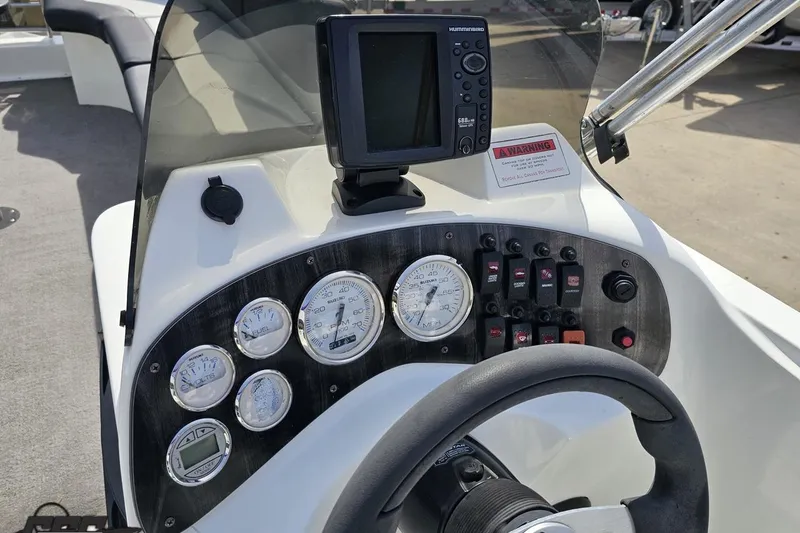 Slide: The Image of Control panel of 2014 Caravelle 247 UU Razor E-Toon boat with gauges and navigation system. - 52