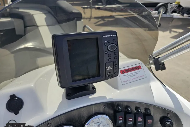 Slide: The Image of Dashboard of 2014 Caravelle 247 UU Razor E-Toon with Humminbird GPS and warning label. - 53