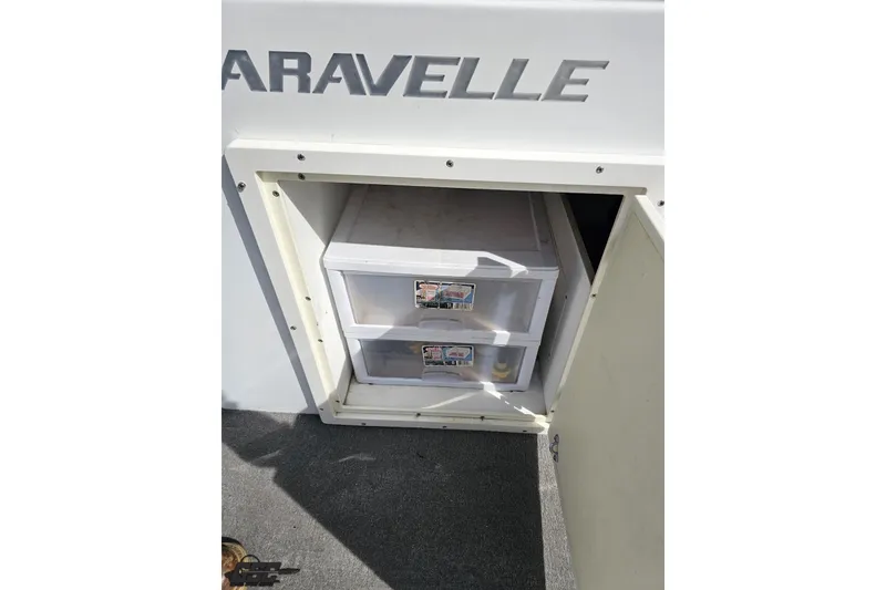 Slide: The Image of Open storage compartment on 2014 Caravelle 247 UU Razor E-Toon boat. - 60