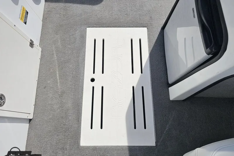 Slide: The Image of Interior of 2014 Caravelle 247 UU Razor E-Toon boat, featuring a white floor panel. - 62