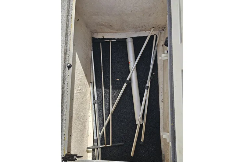 Slide: The Image of Storage compartment of 2014 Caravelle 247 UU Razor E-Toon with metal poles. - 63