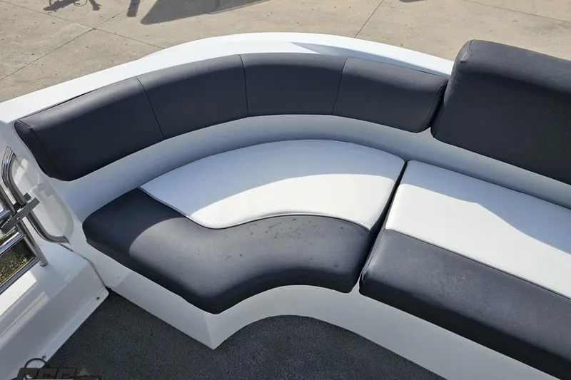 Slide: The Image of Curved seating on 2014 Caravelle 247 UU Razor E-Toon boat, featuring black and white upholstery. - 69