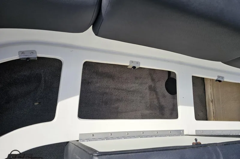 Slide: The Image of Interior view of a 2014 Caravelle 247 UU Razor E-Toon boat, showcasing seating and storage. - 70
