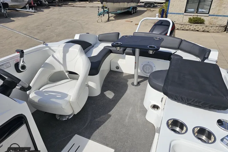 Slide: The Image of 2014 Caravelle 247 UU Razor E-Toon boat interior with seating and table setup. - 81