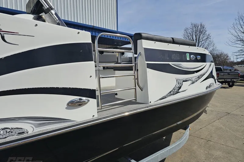 Slide: The Image of 2014 Caravelle 247 UU Razor E-Toon boat with sleek black and white design. - 9