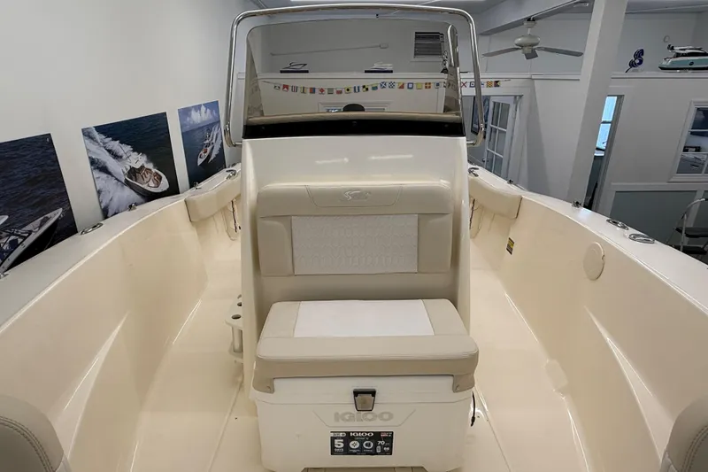 Slide: The Image of 2026 Scout 195 Sportfish boat interior with seating and helm station. - 12