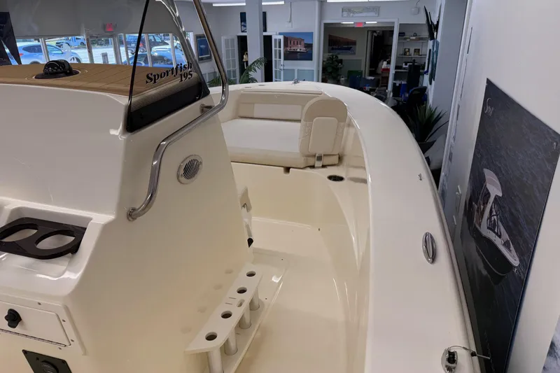 Slide: The Image of 2026 Scout 195 Sportfish boat interior with seating and fishing rod holders. - 13