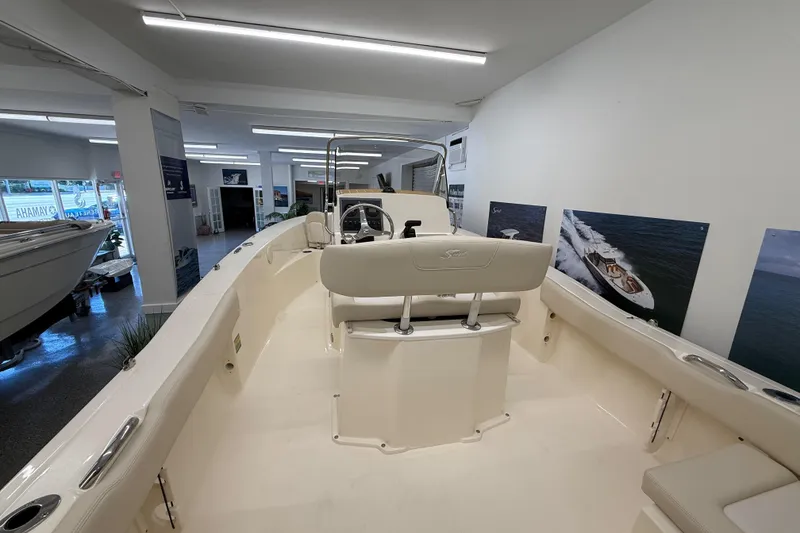Slide: The Image of 2026 Scout 195 Sportfish boat interior in showroom, featuring sleek design and modern amenities. - 4