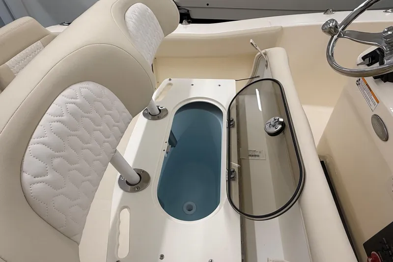 Slide: The Image of 2026 Scout 195 Sportfish boat interior with seating and storage compartment. - 9