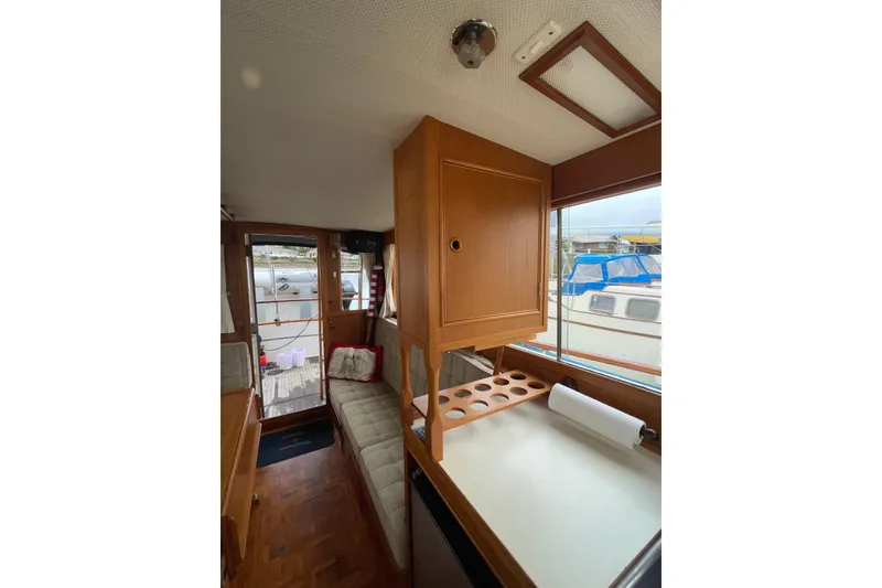 Slide: The Image of Interior of 1982 Grand Banks 32 Sedan, featuring wooden cabinetry and seating area. - 18