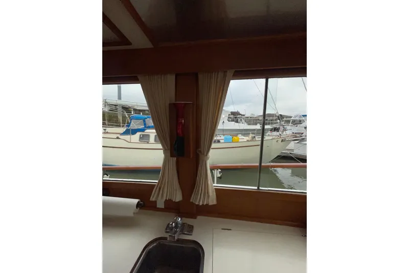 Slide: The Image of Interior view from 1982 Grand Banks 32 Sedan, showcasing marina through window. - 20