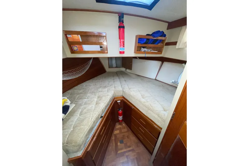 Slide: The Image of Cozy cabin interior of 1982 Grand Banks 32 Sedan with storage and bedding. - 22