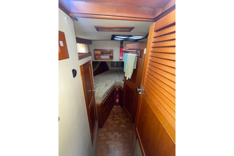 Slide: The Image of Interior of 1982 Grand Banks 32 Sedan, featuring cozy cabin with wooden finishes. - 23
