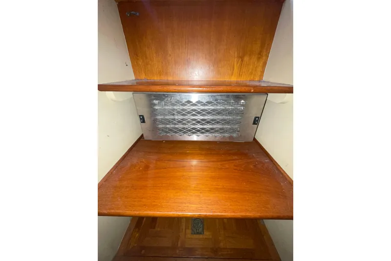 Slide: The Image of Wooden interior shelving with metal vent in 1982 Grand Banks 32 Sedan boat. - 26