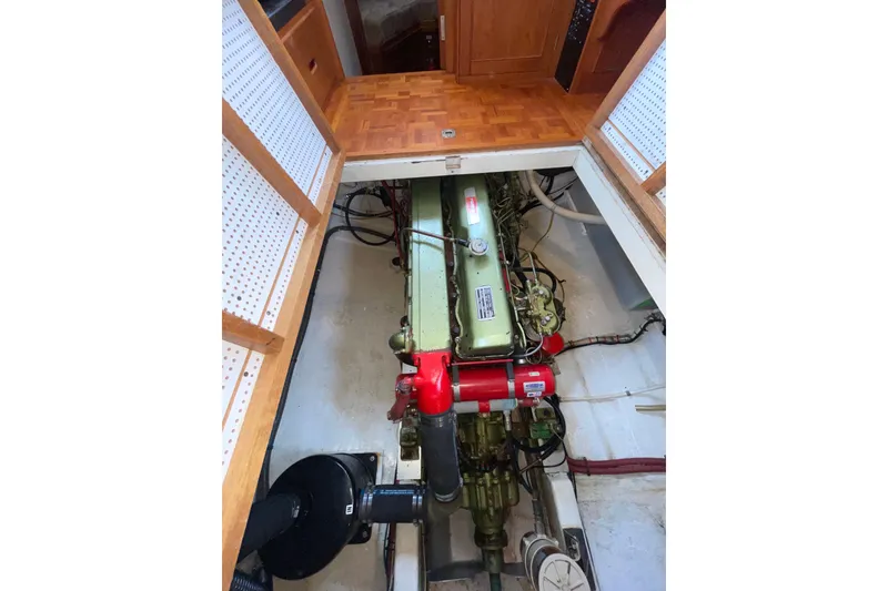 Slide: The Image of Engine compartment of a 1982 Grand Banks 32 Sedan, showcasing detailed mechanical components. - 27