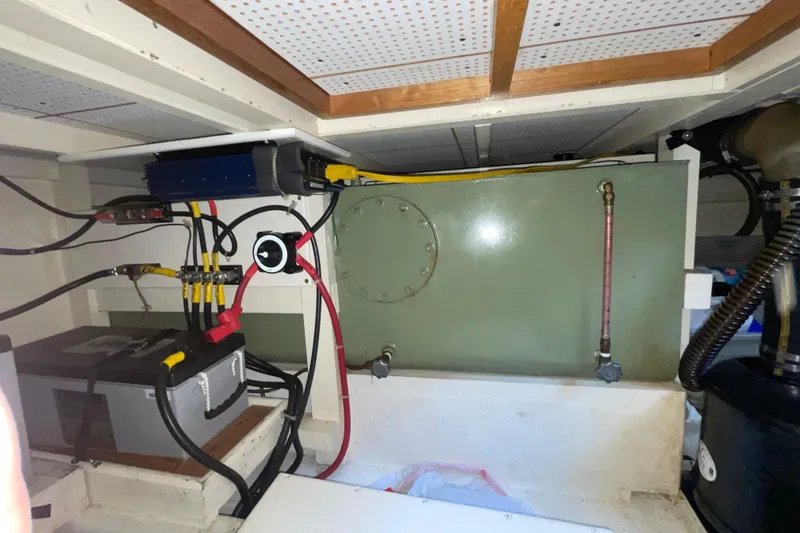 Slide: The Image of Engine room of a 1982 Grand Banks 32 Sedan, showcasing wiring and equipment. - 28