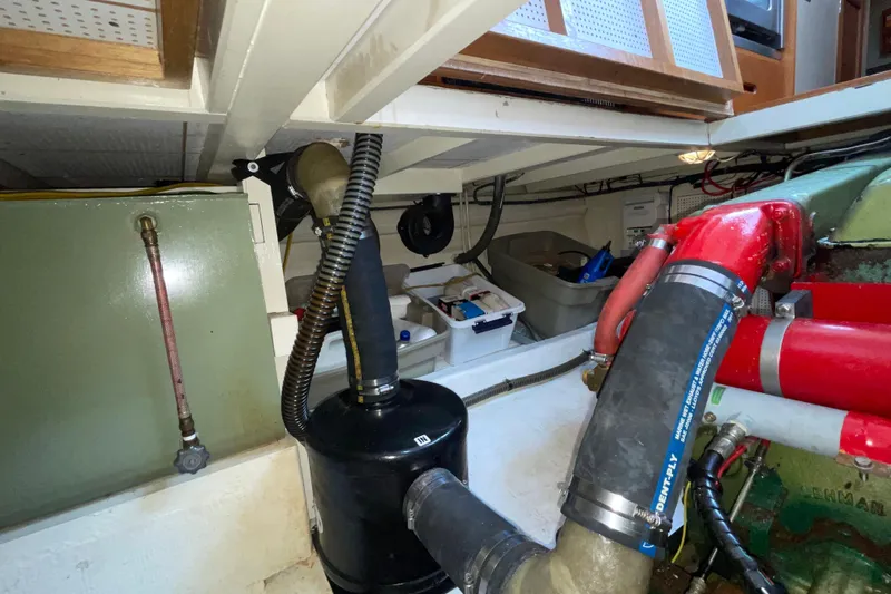 Slide: The Image of Engine room of 1982 Grand Banks 32 Sedan with visible hoses and components. - 29