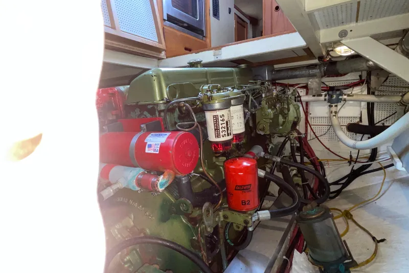 Slide: The Image of Engine room of 1982 Grand Banks 32 Sedan with visible filters and wiring. - 32