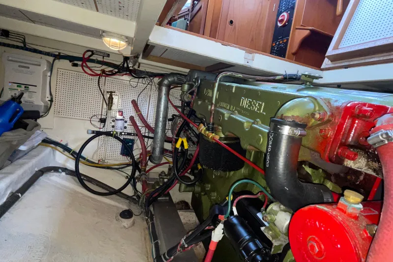 Slide: The Image of Engine room of a 1982 Grand Banks 32 Sedan with visible diesel engine components. - 39