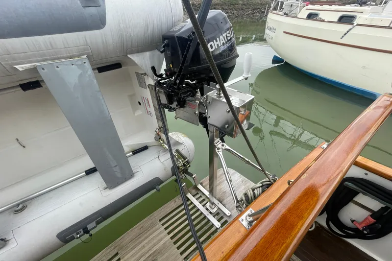 Slide: The Image of 1982 Grand Banks 32 Sedan with dinghy and outboard motor on water. - 43