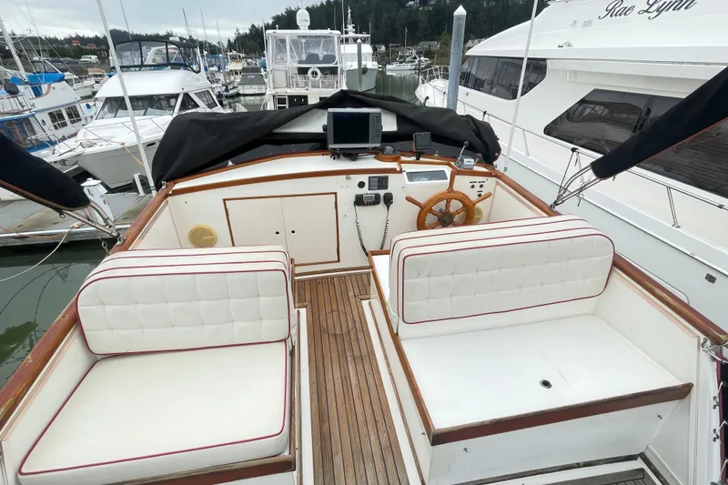 Slide: The Image of 1982 Grand Banks 32 Sedan boat interior with wooden deck and cushioned seating. - 47