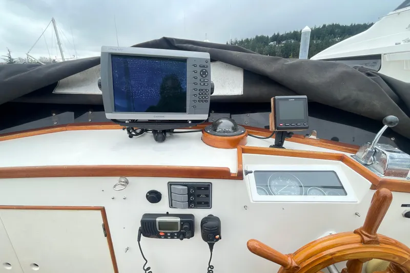 Slide: The Image of Helm of 1982 Grand Banks 32 Sedan with navigation equipment and wooden steering wheel. - 48