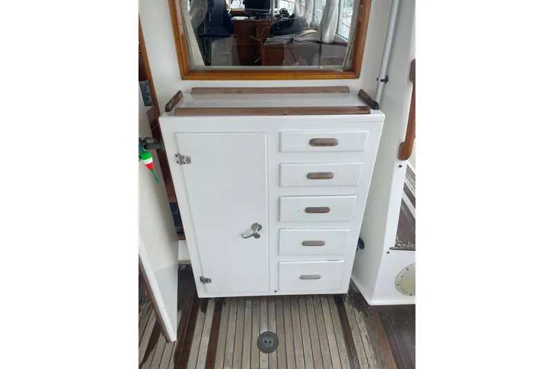 Slide: The Image of White cabinet with drawers on a 1982 Grand Banks 32 Sedan boat interior. - 51