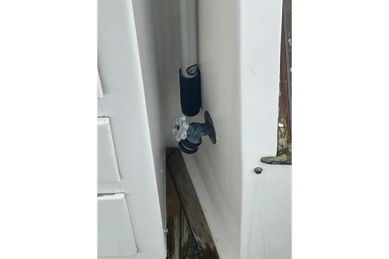 Slide: The Image of Water valve on 1982 Grand Banks 32 Sedan boat, featuring white and wooden surfaces. - 52