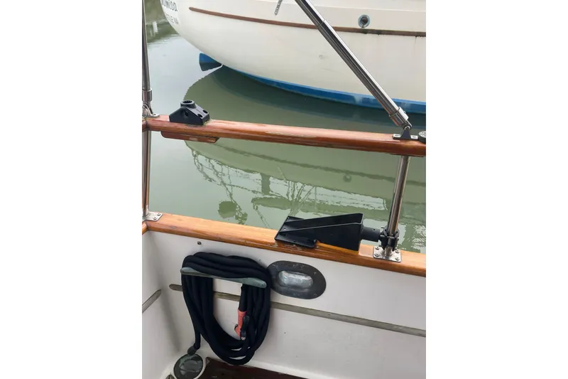 Slide: The Image of 1982 Grand Banks 32 Sedan boat deck with railing and docked reflection. - 53