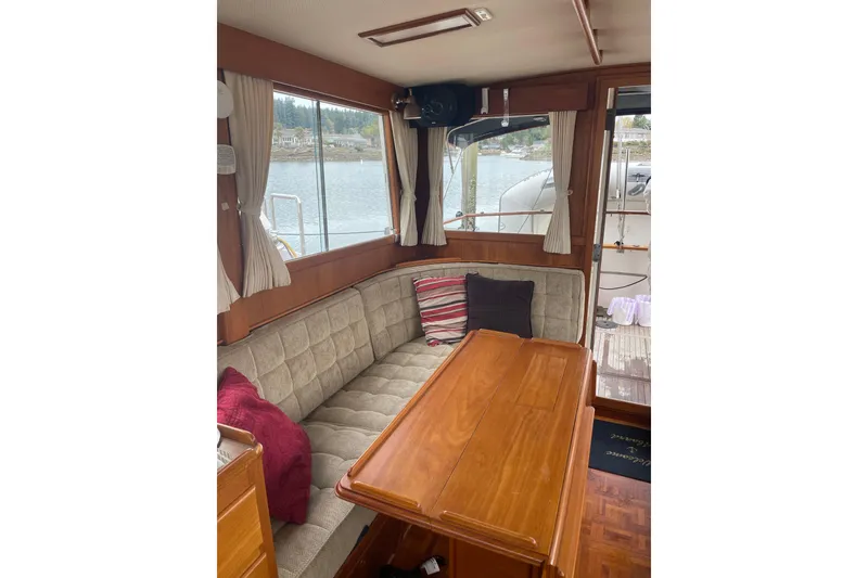 Slide: The Image of Interior of 1982 Grand Banks 32 Sedan with cozy seating and wooden table. - 6