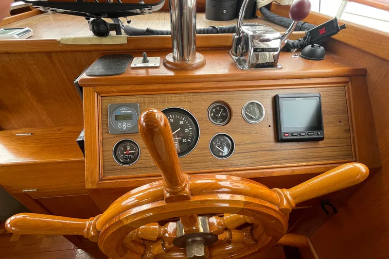 Slide: The Image of 1982 Grand Banks 32 Sedan helm with wooden wheel and navigation instruments. - 7