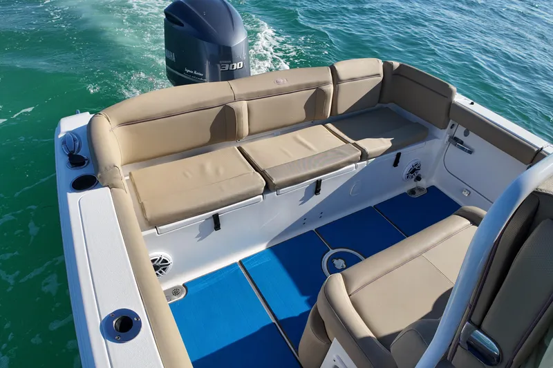 Slide: The Image of 2018 Sea Hunt Ultra 255 SE boat interior with beige seating and Yamaha engine. - 12