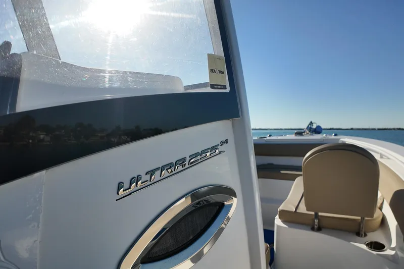 Slide: The Image of 2018 Sea Hunt Ultra 255 SE boat on calm water, sunny day. - 14