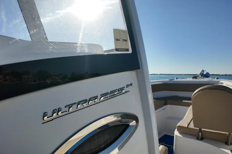 Slide: The Image of 2018 Sea Hunt Ultra 255 SE boat on calm water, sunny day. - 15