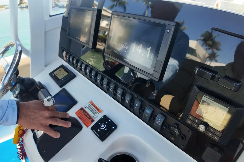 Slide: The Image of Control panel of a 2018 Sea Hunt Ultra 255 SE boat with navigation screens. - 21