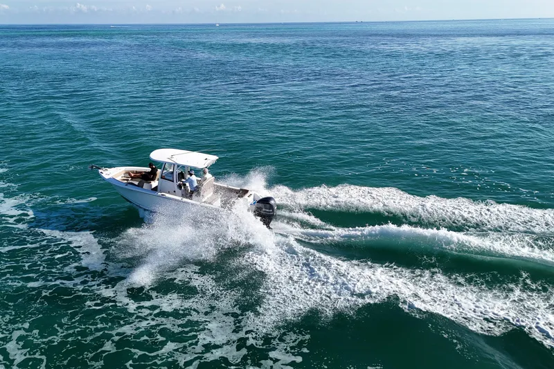 Slide: The Image of 2018 Sea Hunt Ultra 255 SE boat cruising on open ocean waters. - 23