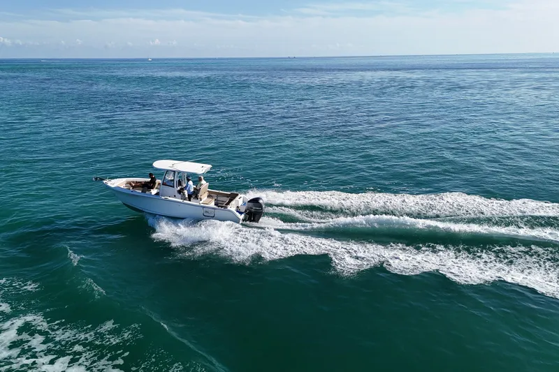 Slide: The Image of 2018 Sea Hunt Ultra 255 SE boat cruising on open ocean waters. - 7