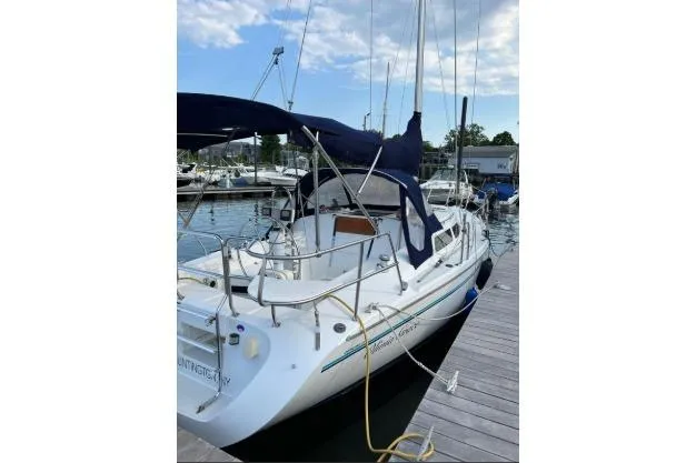The Image of 1997 Catalina 28 MkII sailboat docked at marina under blue sky. - 1