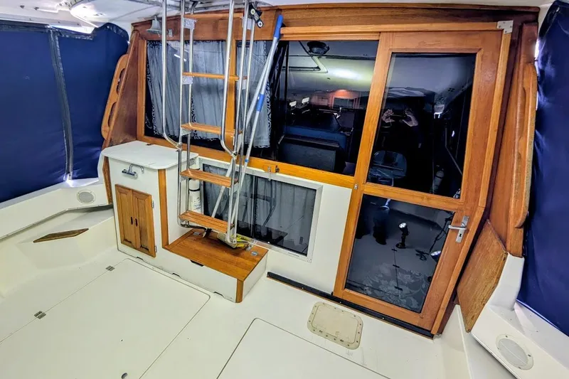 Slide: The Image of 1986 Bayliner 3270 Motoryacht interior with wooden accents and ladder. - 10