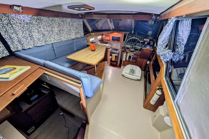 Slide: The Image of Interior of 1986 Bayliner 3270 Motoryacht with seating, table, and helm station. - 12