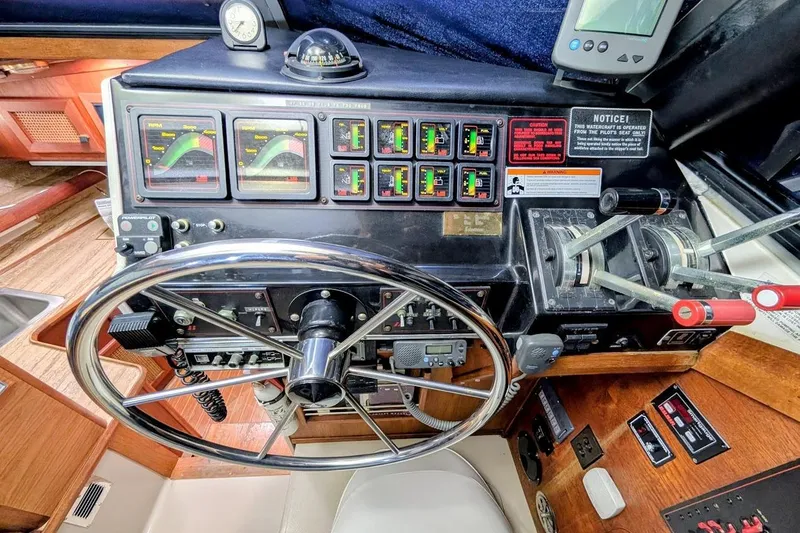 Slide: The Image of Control panel of a 1986 Bayliner 3270 Motoryacht with steering wheel and gauges. - 15