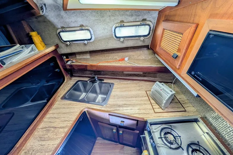 Slide: The Image of Interior of 1986 Bayliner 3270 Motoryacht kitchen with sink, stove, and wooden cabinetry. - 22