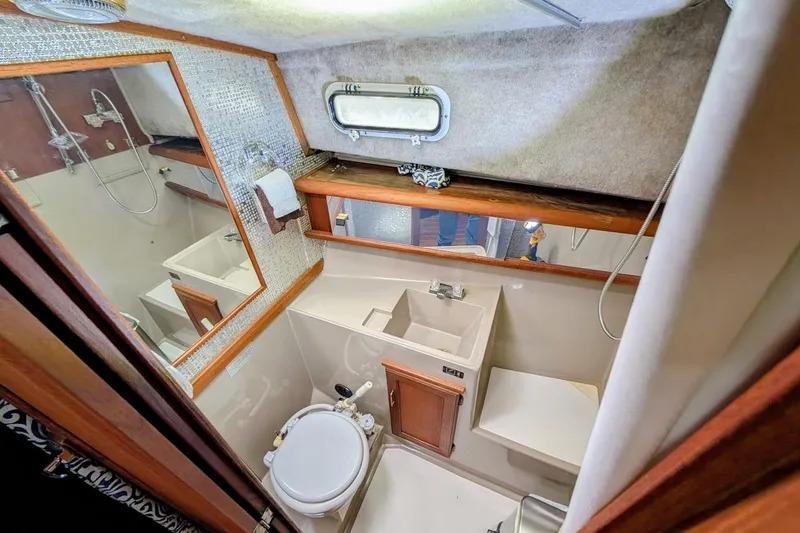 Slide: The Image of Bathroom interior of 1986 Bayliner 3270 Motoryacht with sink, toilet, and shower. - 23