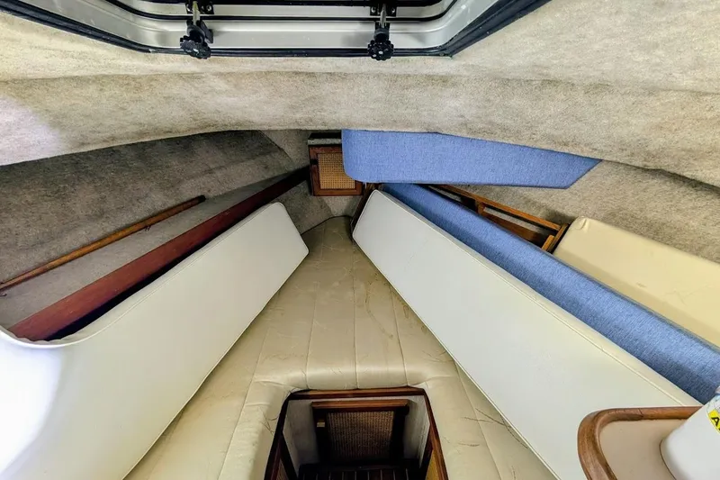 Slide: The Image of Interior cabin of 1986 Bayliner 3270 Motoryacht with cushioned seating and wooden accents. - 25