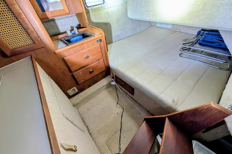 Slide: The Image of Interior cabin of 1986 Bayliner 3270 Motoryacht with bed, sink, and storage drawers. - 26