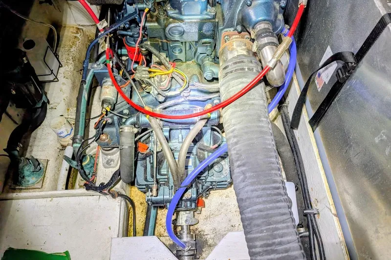 Slide: The Image of Engine compartment of a 1986 Bayliner 3270 Motoryacht, showcasing wiring and hoses. - 29