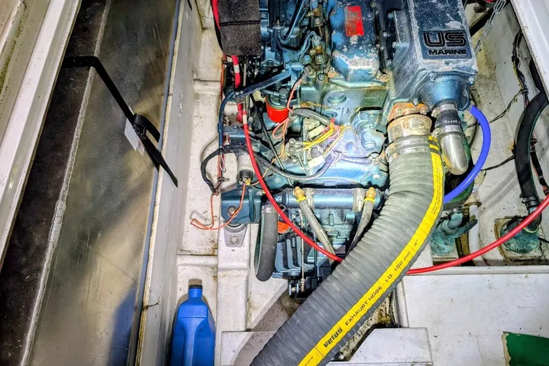 Slide: The Image of Engine compartment of a 1986 Bayliner 3270 Motoryacht with visible hoses and wiring. - 31